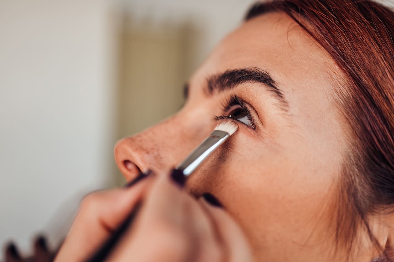 bridal makeup artist working bride wedding preparation
