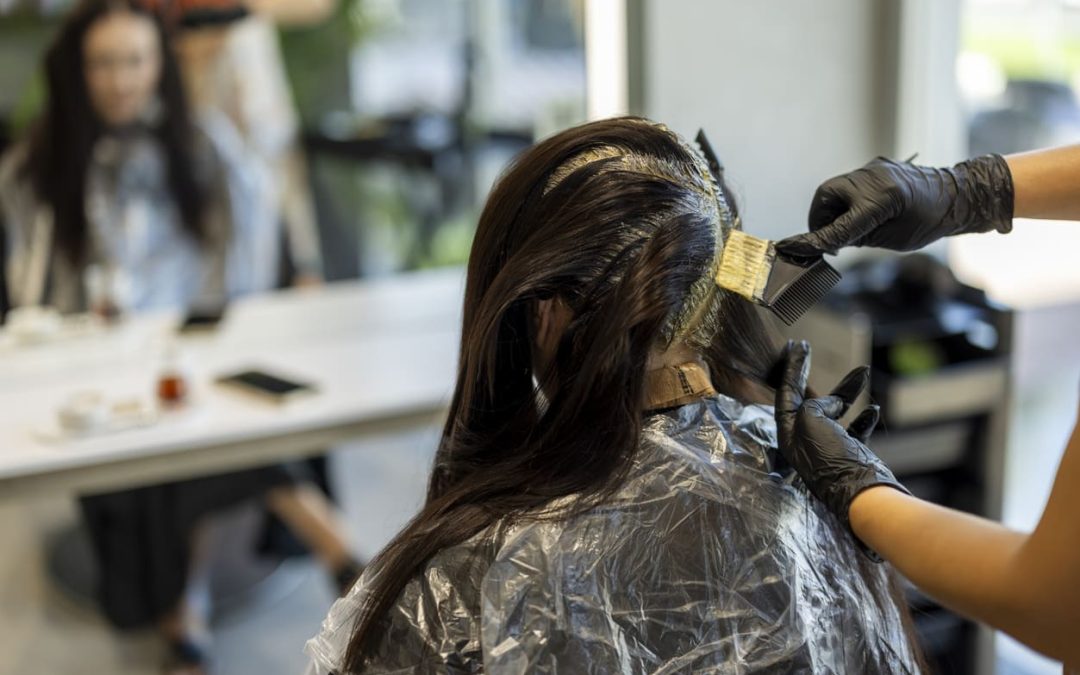 hair stylist applying hair color balayage salon