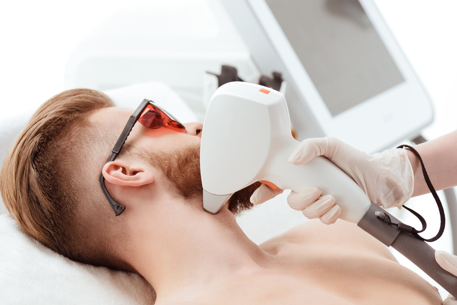 young man receiving laser skin care on face. healthy lifestyle man concept Cheek Laser Hair Removal in Brampton